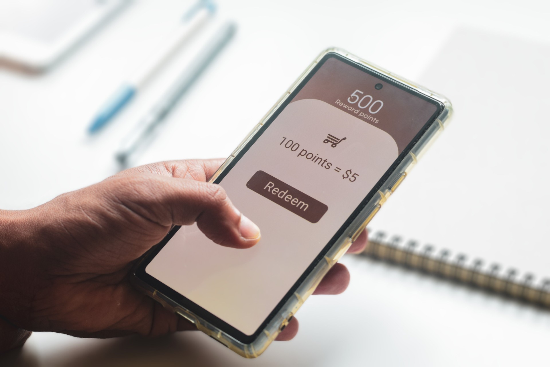 Man trying to transfer redeem rewards points into cash on his mobile phone. Loyalty programs to increase customer engagement in digital marketing concepts. Selective focus.